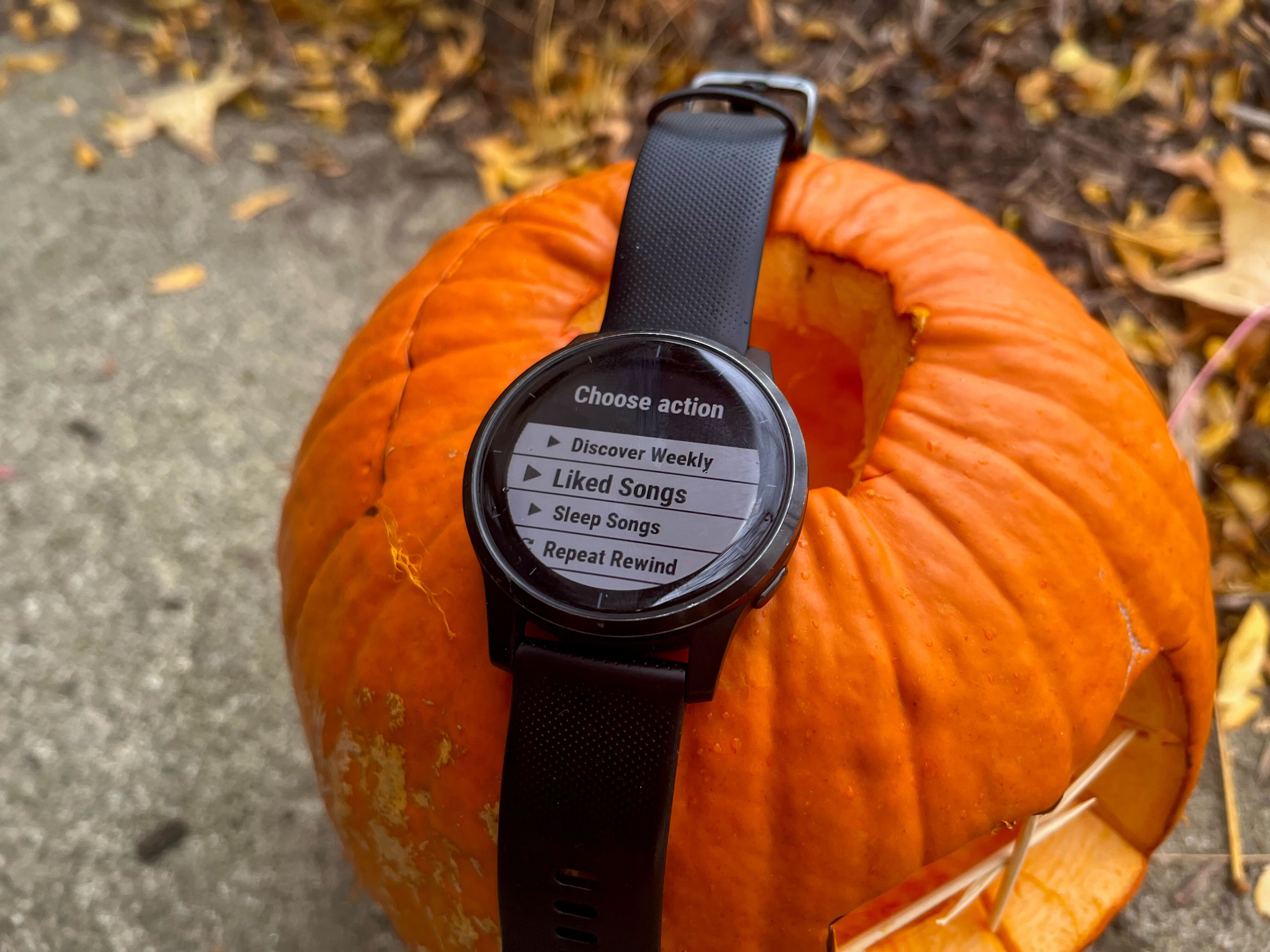 a garmin watch with the apicall app open to a spotify page